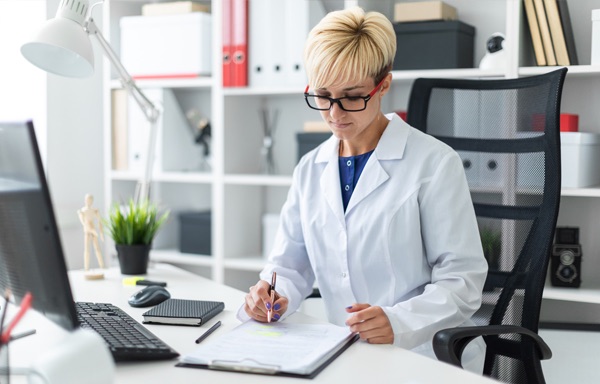 Female hospital administrator working at desk